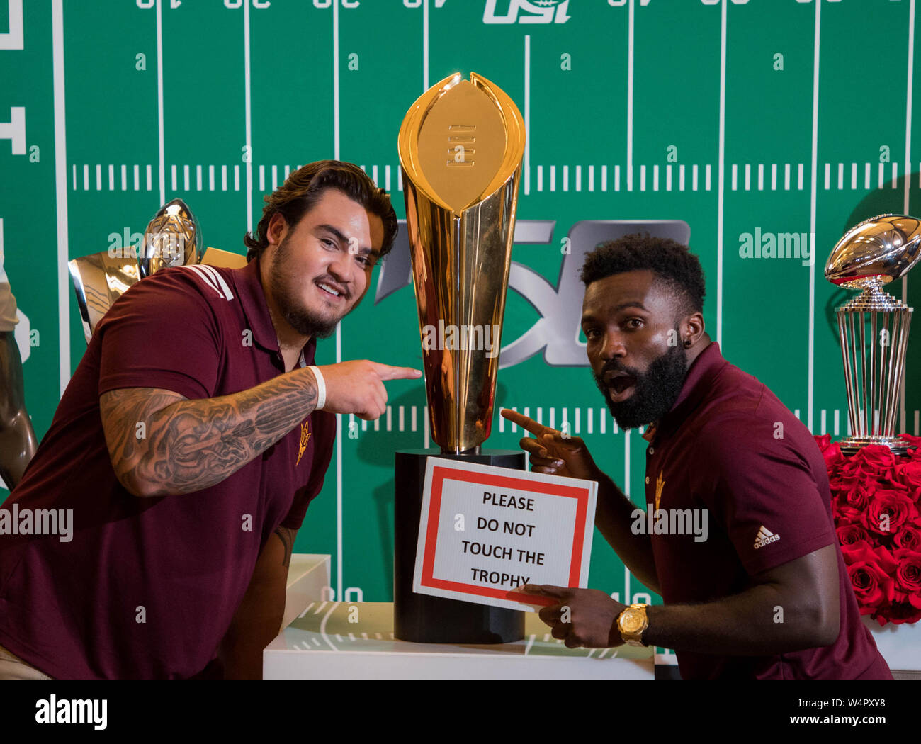 Hollywood, CA. 24th July, 2019. Arizona State Sun Devils running back Eno Benjamin and teammate Cohl Cabral having some fun in front of the Rose Bowl and National Championship trophies at the Pac-12 football media day on Wednesday, July 24, 2019 at the Hollywood and Highland, in Hollywood, CA. (Mandatory Credit: Juan Lainez/MarinMedia.org/Cal Sport Media) (Complete photographer, and credit required) Credit: csm/Alamy Live News Stock Photo