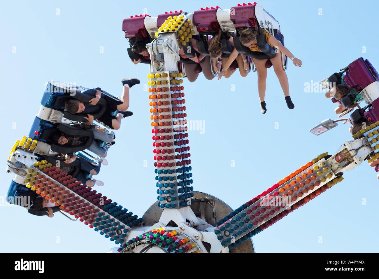 People riding an amusement park ride at a county fair in Oregon, USA ...
