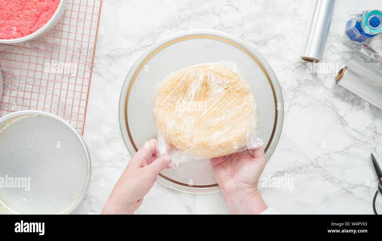 Step by step. Flat lay. Removing freshly baked cake layers from the