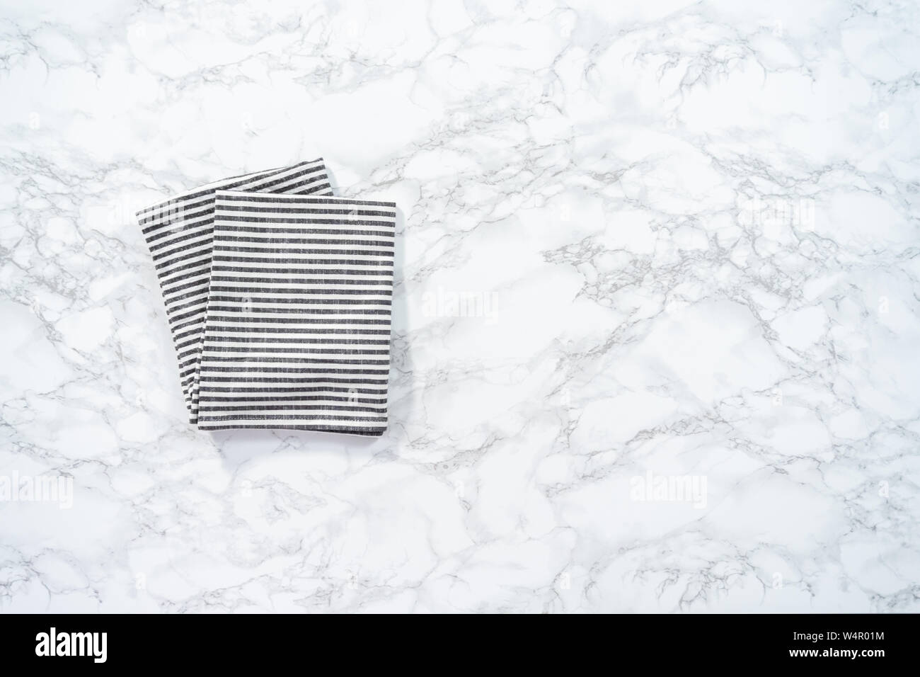 Flat lay. Kitchen towels with white and black stripes on the marble counter Stock Photo Alamy