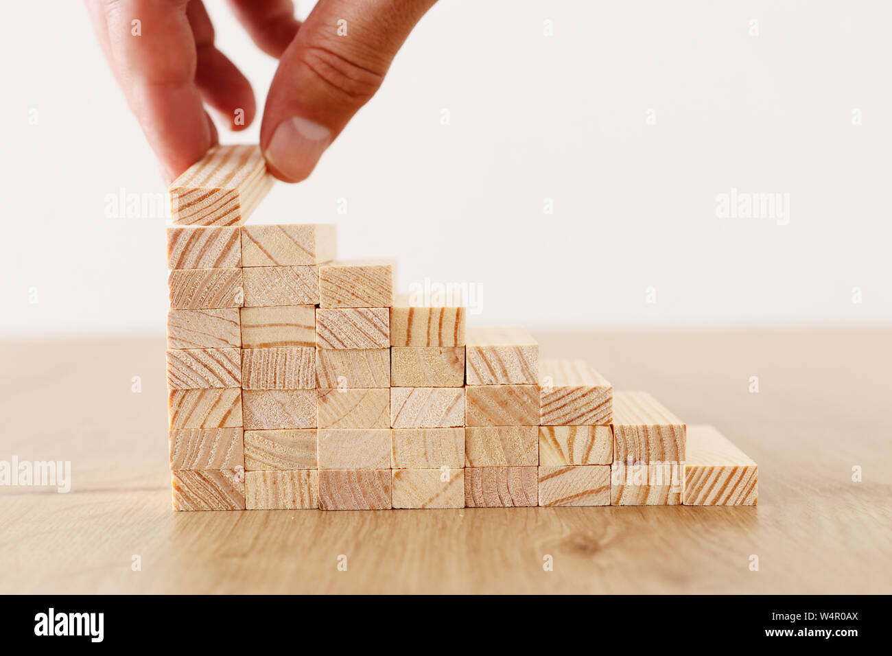 Business image of arranging wood blocks stacking as step stairs ...