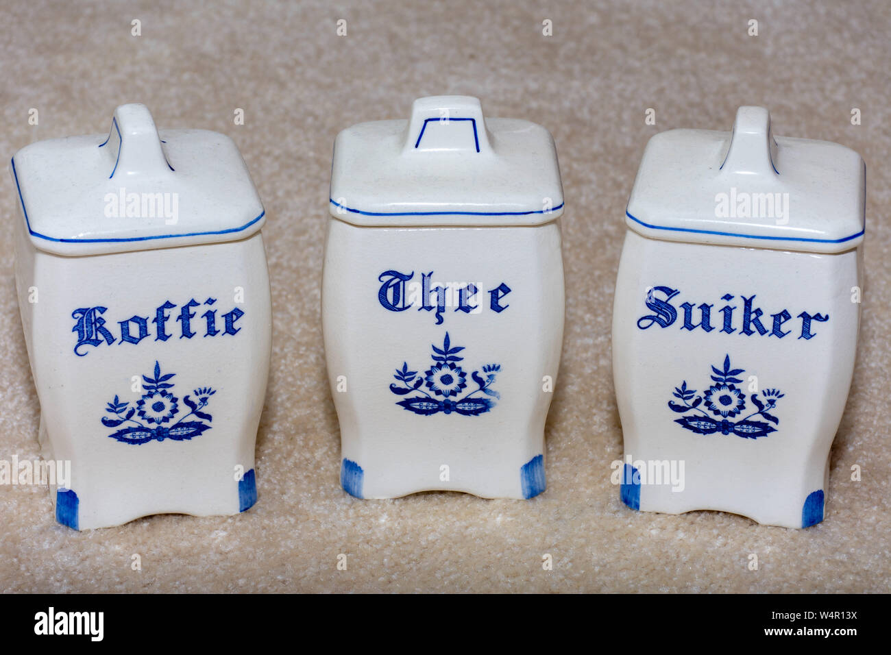 Close up of Delft Blue coffee, and sugar containers. Thee, Suiker. Famous porcelain souvenirs from Holland/Netherlands. Isolated textu Stock Photo -