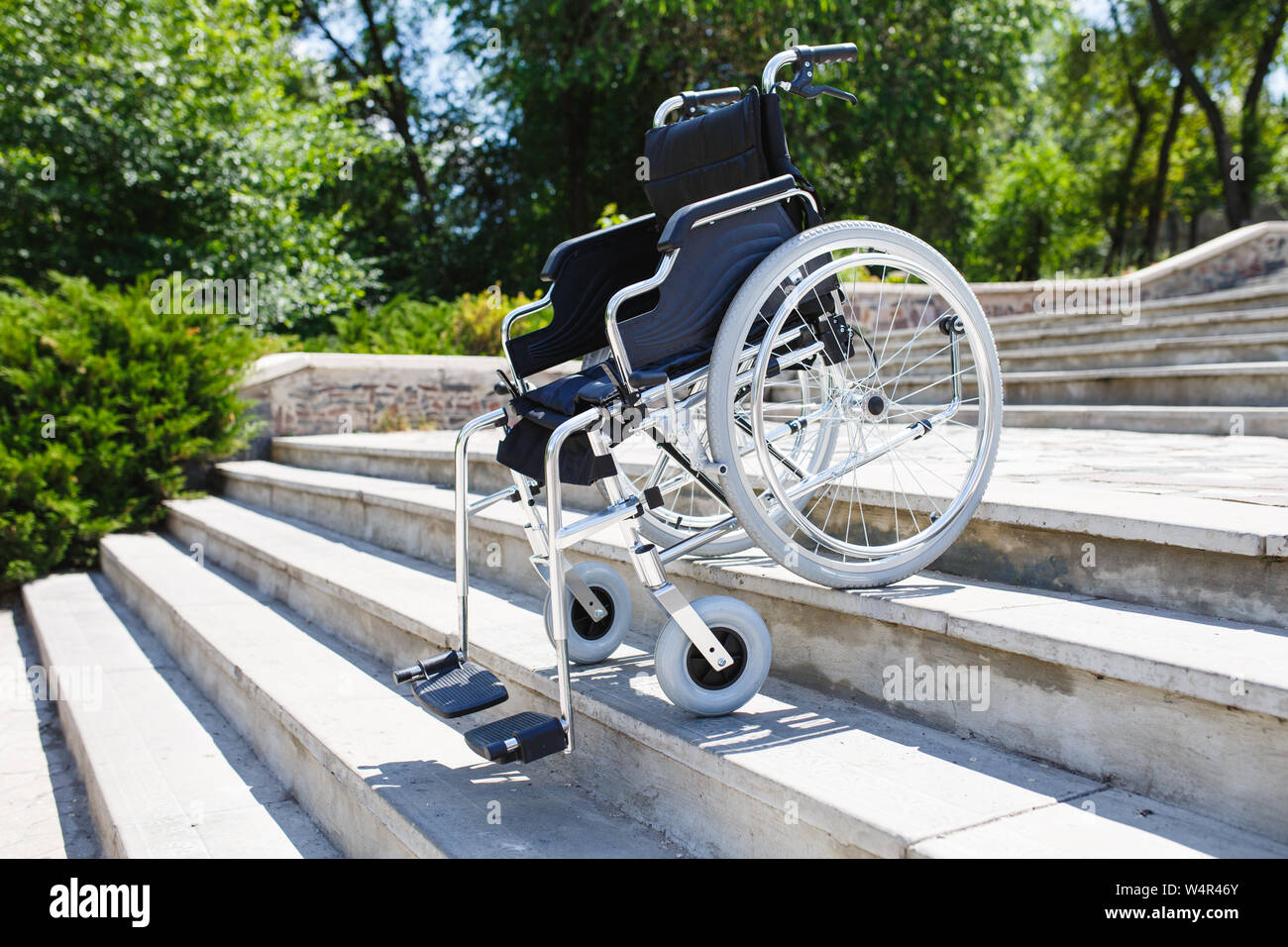 Wheelchair near the steps in a spring park Stock Photo Alamy