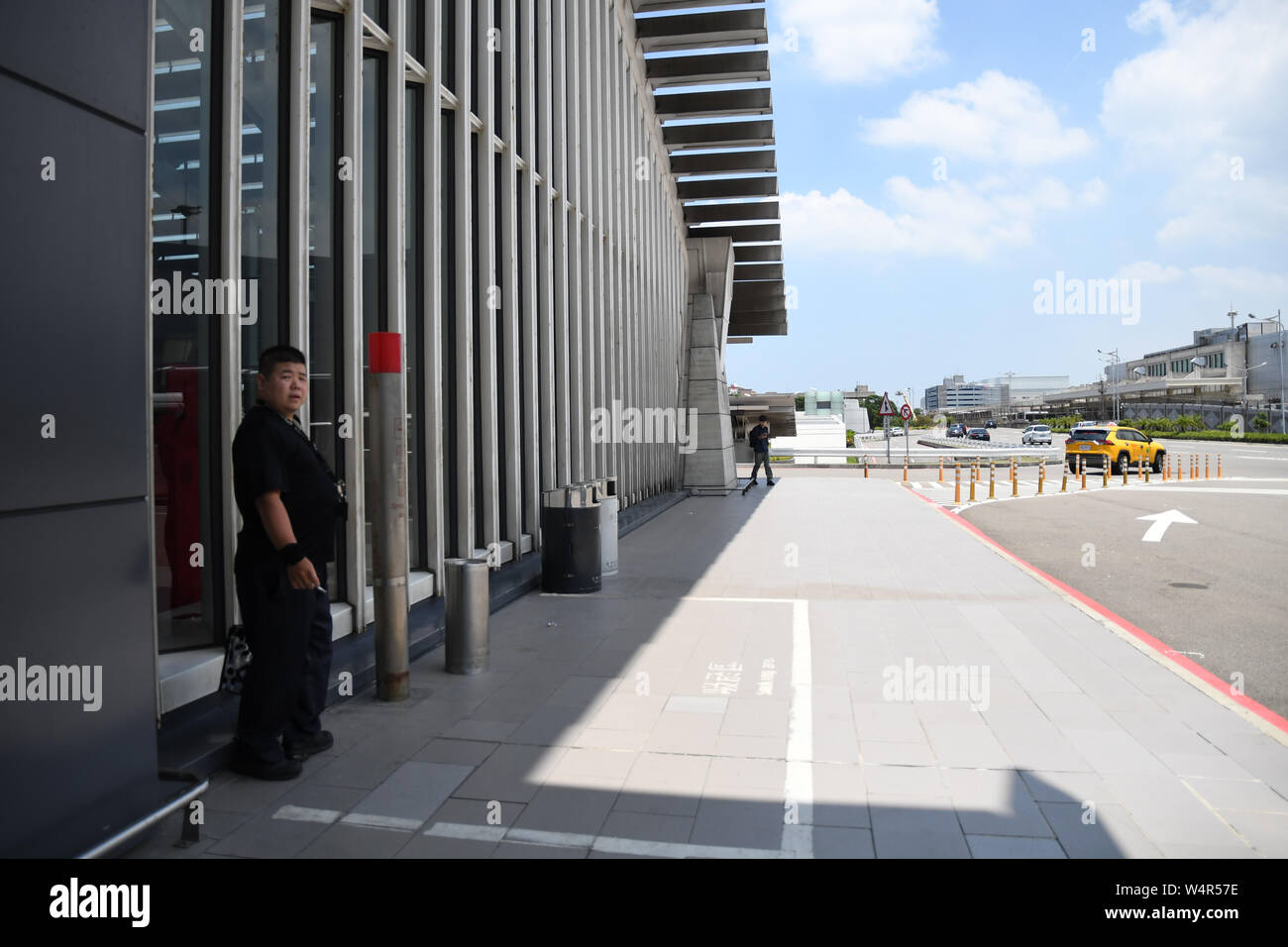 July 24, 2019, Taipei, Taiwan: A man can be seen smoking outside Taiwan's  Taoyuan International Airport located in Dayuan District Taoyuan City.  Taipei is the capital and a special municipality of Taiwan.