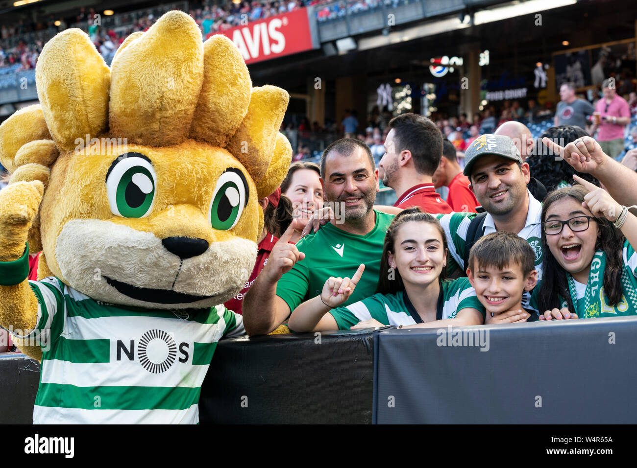New York, NY - July 24, 2019: Sporting CP fans pose with lion Jubas mascot of club before pre-season game against Liverpool FC at Yankee stadium game ended in draw 2 - 2 Stock Photo