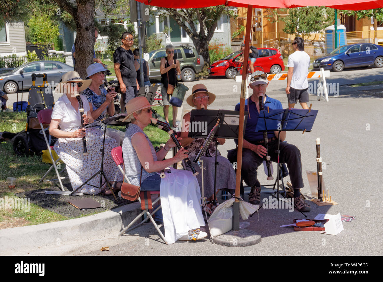 A group of seniors playing recorders at a farmers market in Kitsilano, Vancouver, BC, Canada Stock Photo