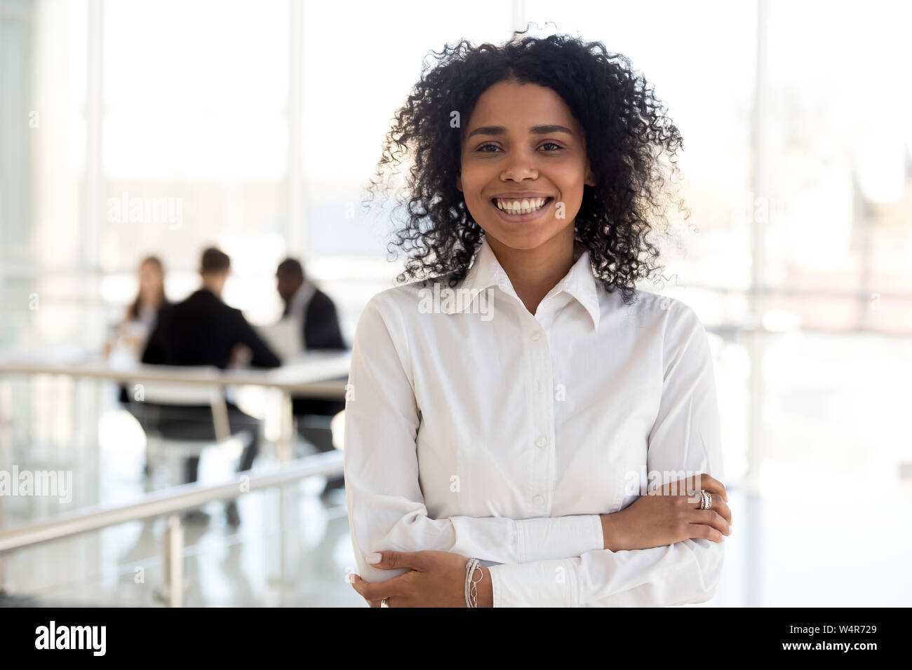 Head shot portrait smiling African American businesswoman in office ...
