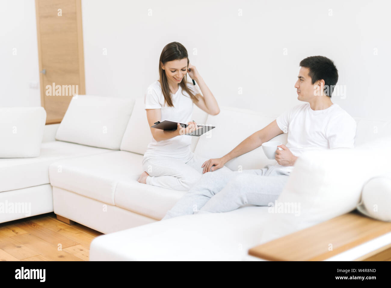 Young woman interviews man in friendly atmosphere. Girl and guy communication Stock Photo