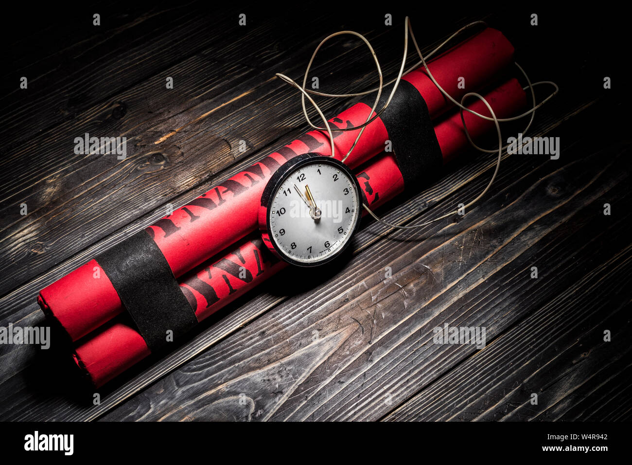 Dynamite bomb with a timer, and a bunch of dynamite on black background. Dynamite is going to explode or detonate per 1 second. Stock Photo