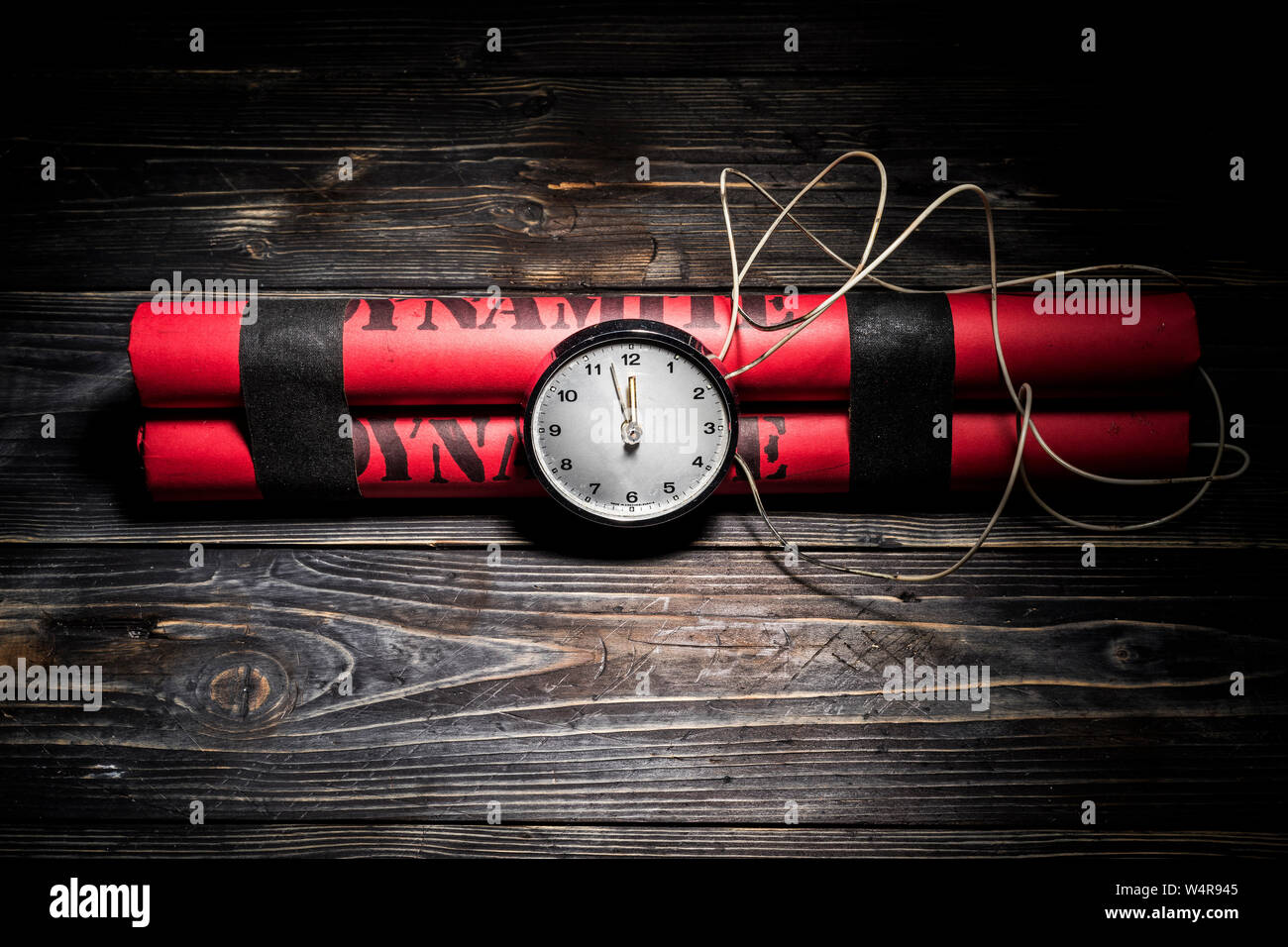 Dynamite bomb with a timer, and a bunch of dynamite on black background. Dynamite is going to explode or detonate per 1 second. Stock Photo