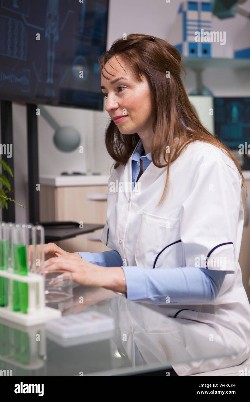 Portrait of focused female microbiology scientist in laboratory. Food