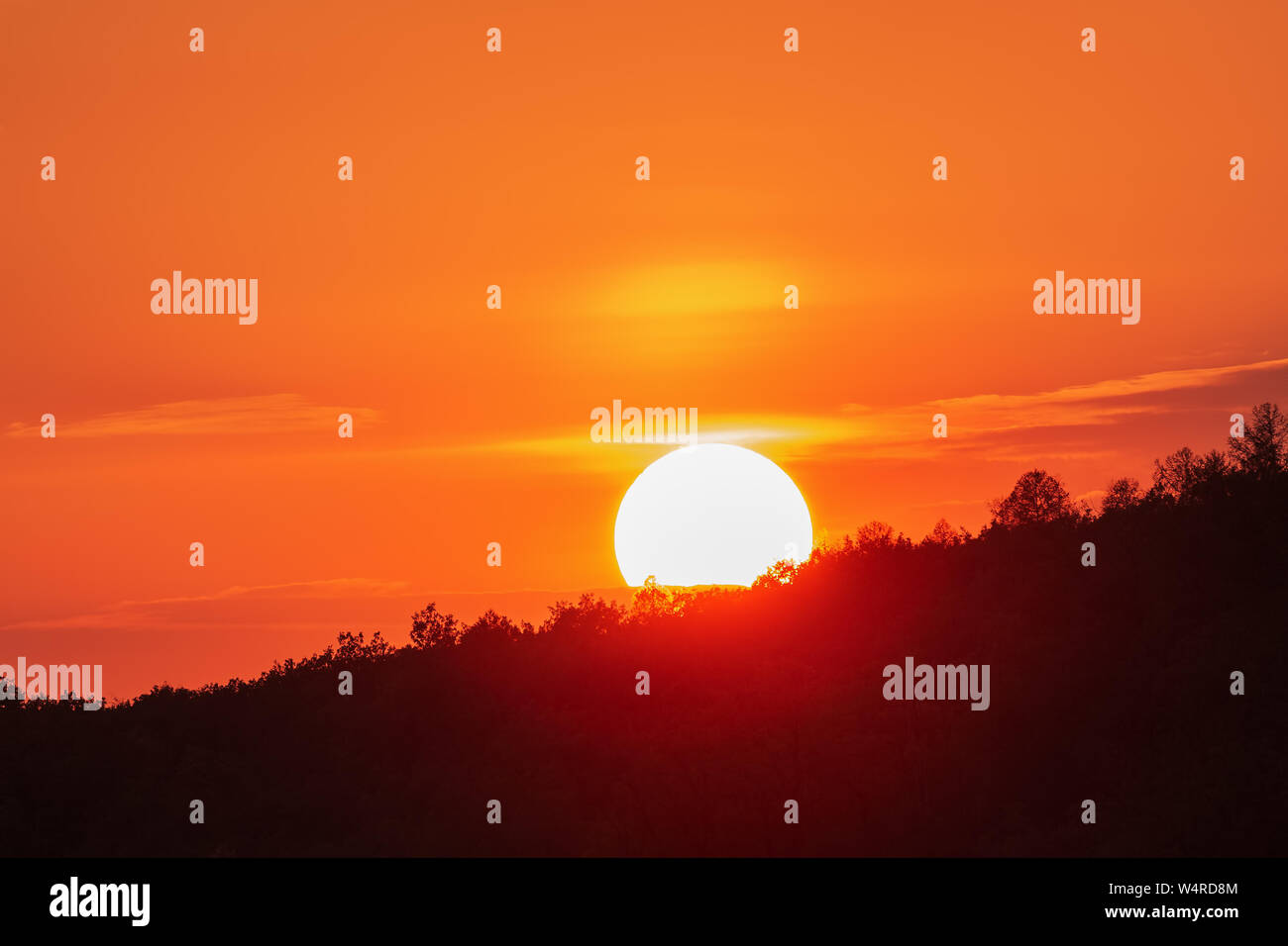 Colorful orange sky with sun at down, romantic background Stock Photo