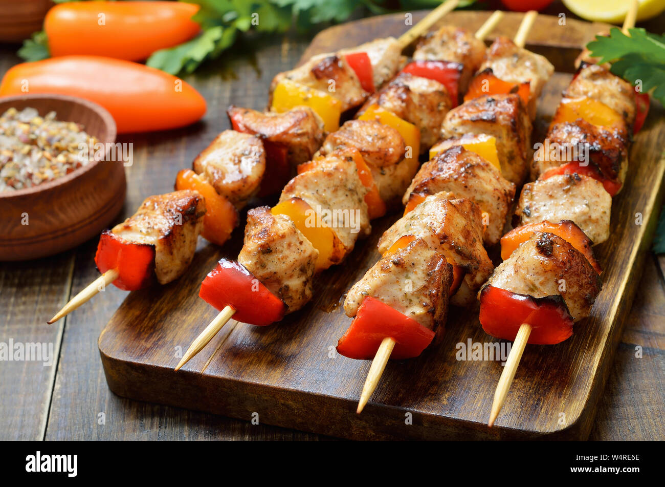 Grilled chicken kebabs on wooden table Stock Photo