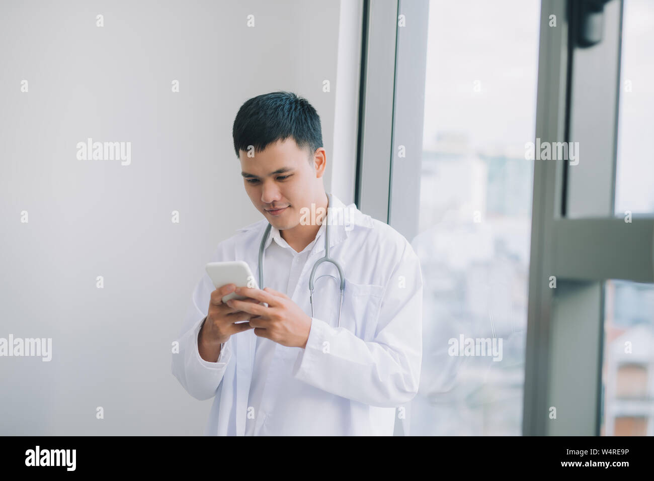 Happy asian doctor holding hi-res stock photography and images - Alamy