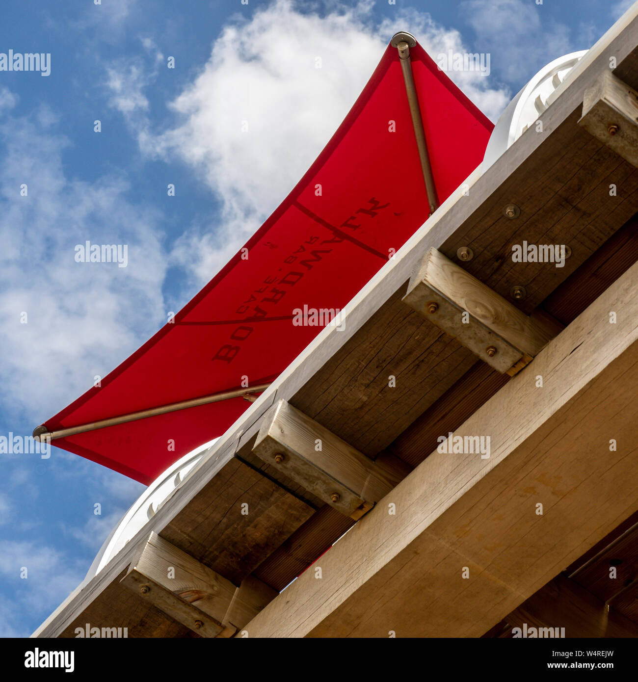 FELIXSTOWE, ESSEX, UK - JULY 18, 2018:  Large Red Umbrella against Blue Sky on the Pier Stock Photo