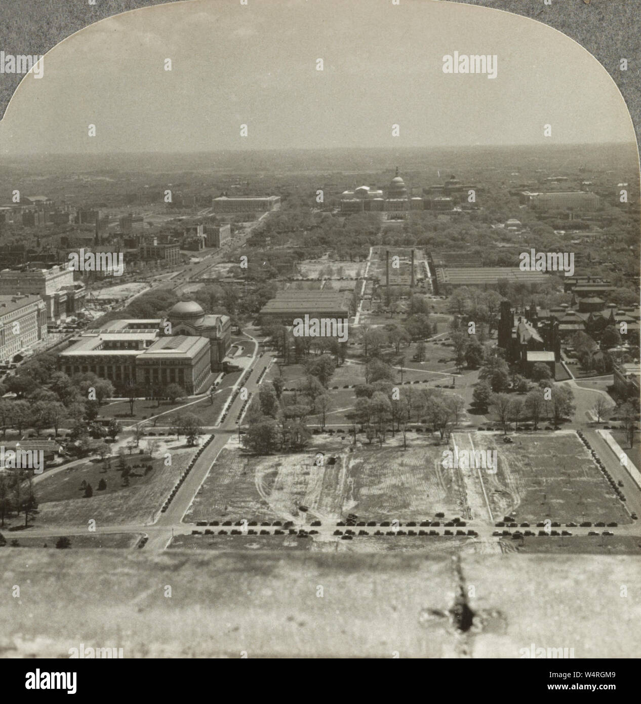 The U.S. Capitol from Washington Monument in 1935. The United States Capitol, often called the Capitol Building, is the home of the United States Congress and the seat of the legislative branch of the U.S. federal government. It is located on Capitol Hill at the eastern end of the National Mall in Washington, D.C. Though no longer at the geographic center of the Federal District, the Capitol forms the origin point for the District's street-numbering system and the District's four quadrants. Stock Photo