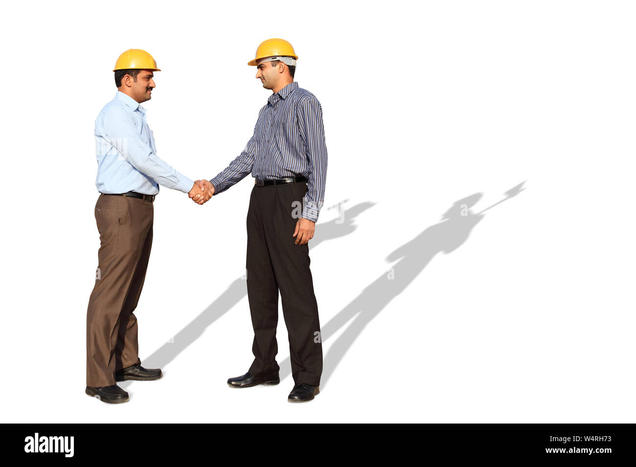 Two engineers shaking hands Stock Photo Alamy