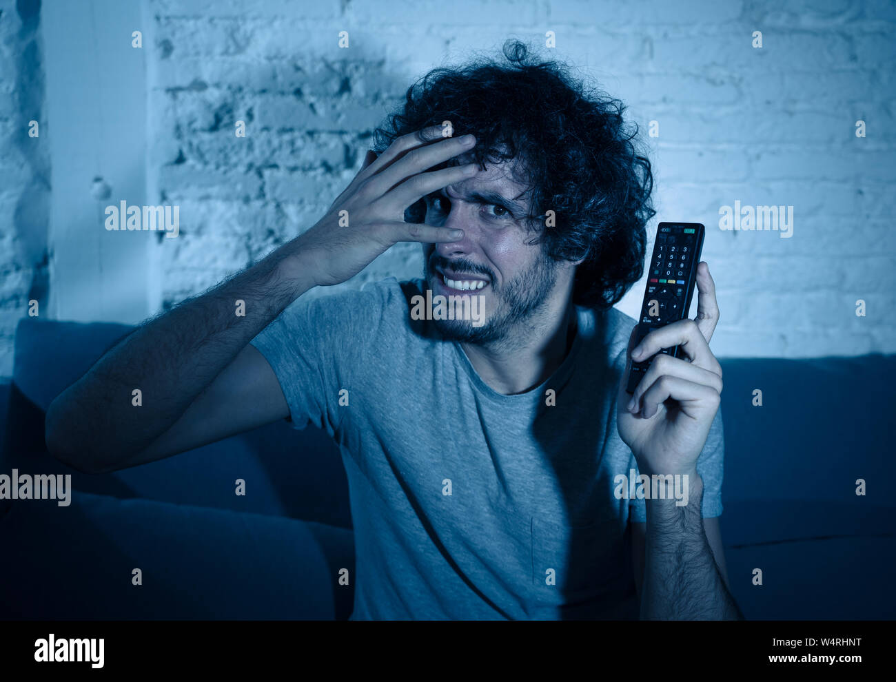 Lifestyle portrait of young man feeling scared and shocked making fear