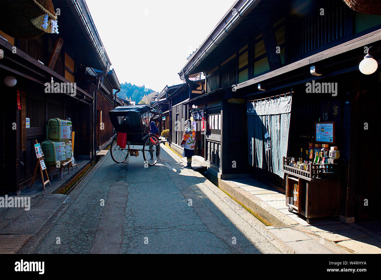 2-wheel rickshaw on stone street with small shops, Hida-Takayama, Takayama, Gifu Prefecture, Japan Stock Photo