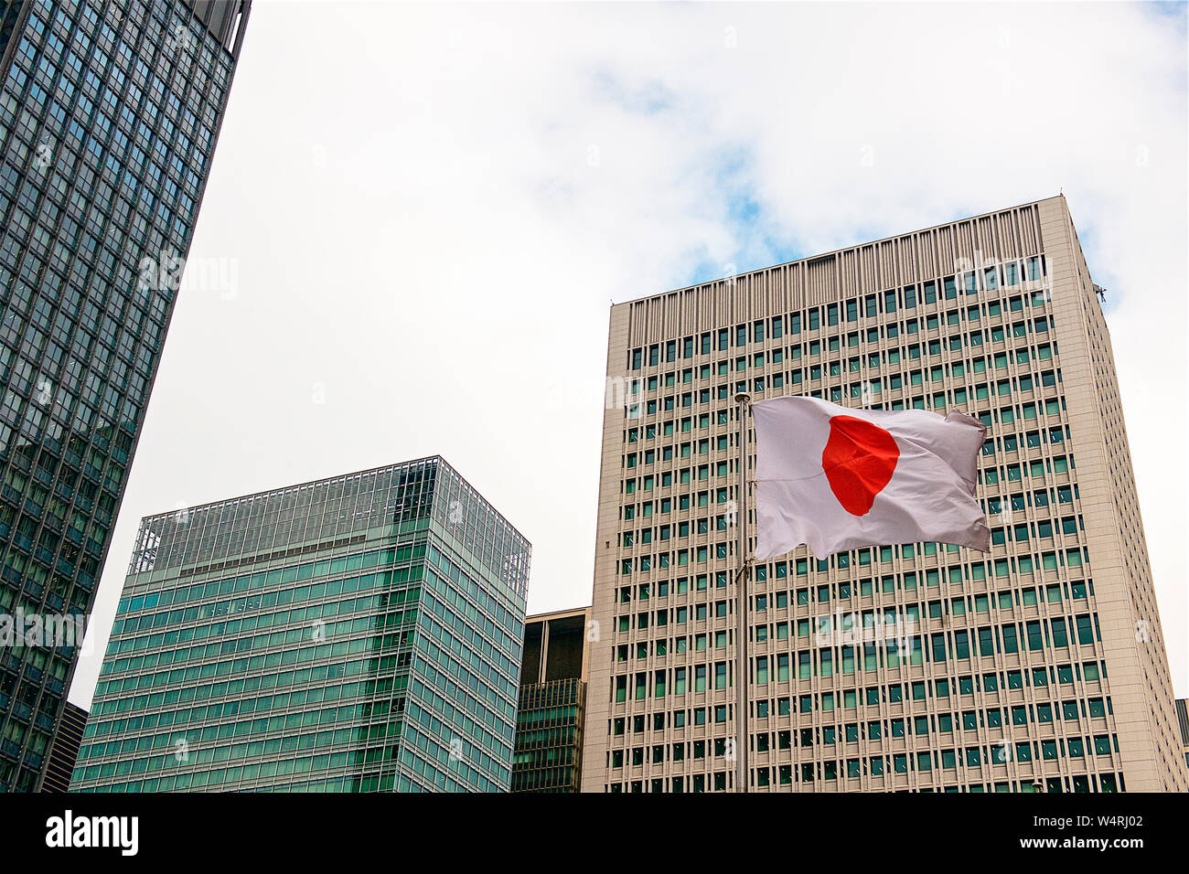 Japanese flag with office buildings on background, Marunouchi, Tokyo, Japan Stock Photo
