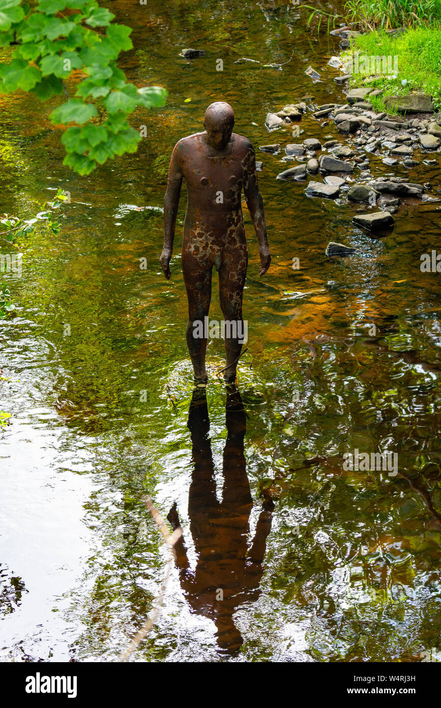 Antony Gormley '6 Times' 'Ground' sculpture in the Water of Leith in Edinburgh, Scotland, UK. comprising six life-size figures, positioned between the Stock Photo