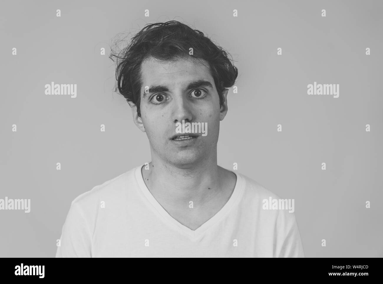 Thinking funny faces. Portrait of worried young man confused