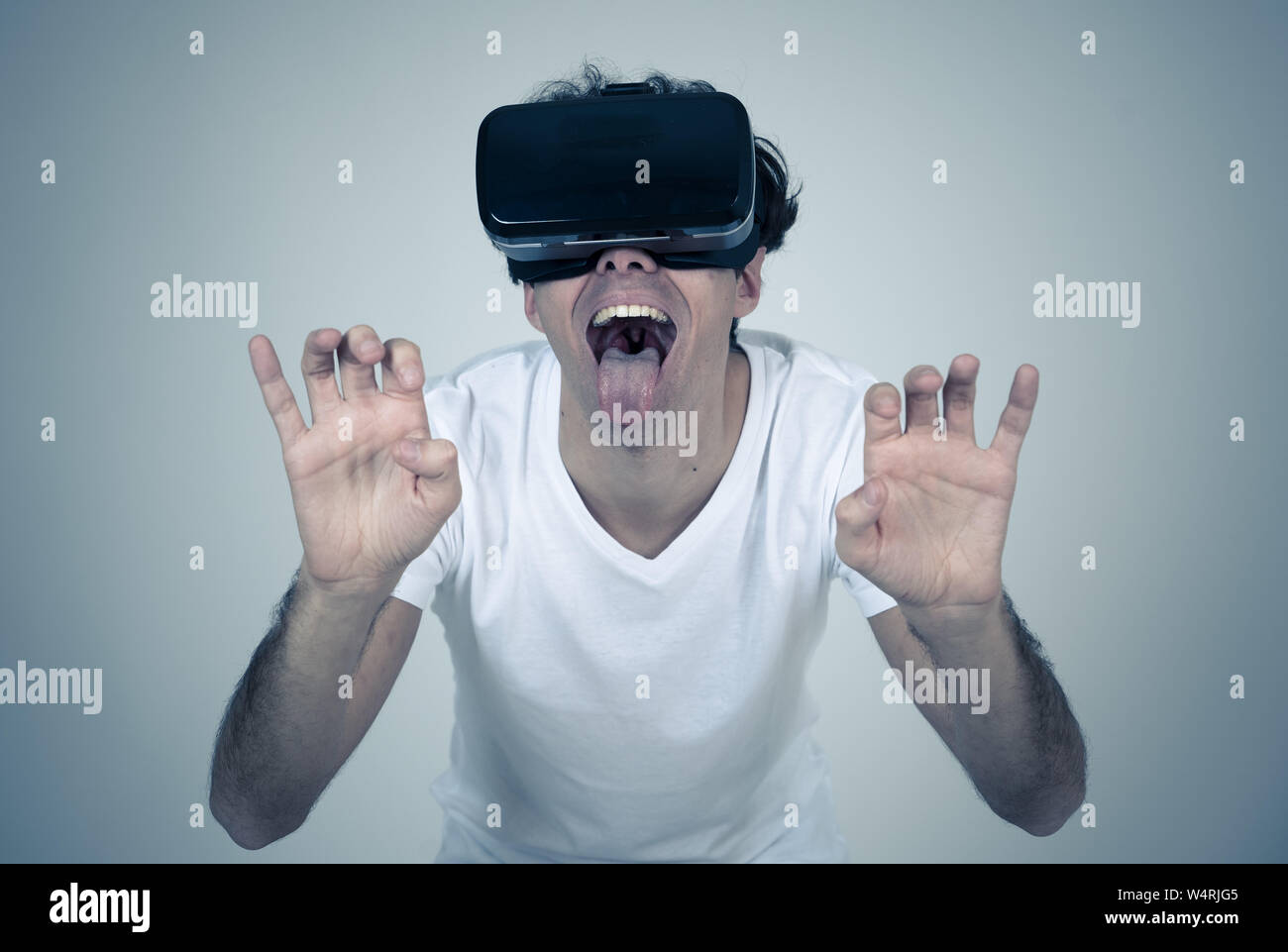 Amazed funny man using VR headset glasses touching and interacting with