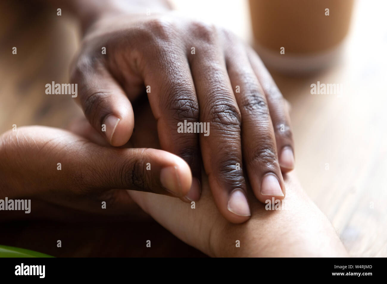 Close up african american male holding young beloved female hands Stock ...