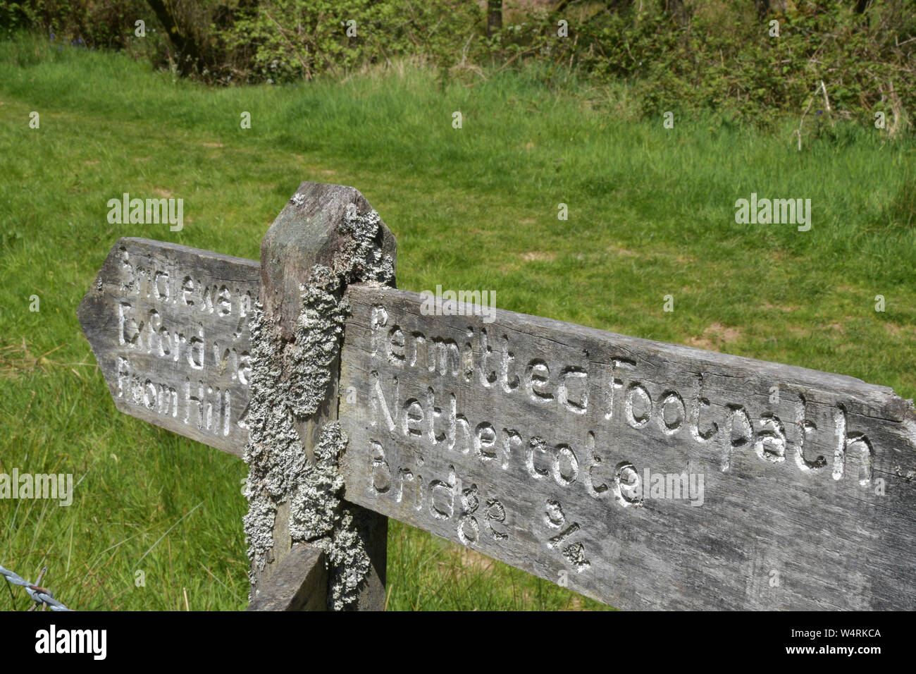 Lichen encrusted fingerpost on the footpath beside the river Exe between Exford and Wishford in Somerset Stock Photo