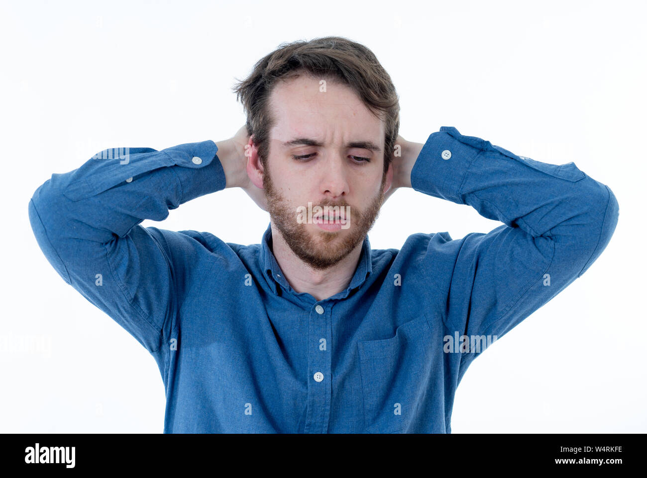 Young sad man suffering from depression. Worried and concerned hipster looking depressed and desperate feeling sorrow. Portrait with copy space. In Pe Stock Photo