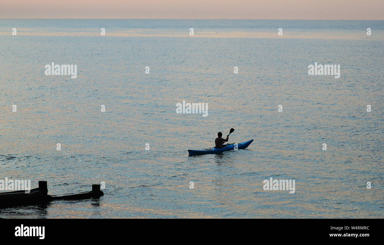 A Kayaker heads out from the beach in Dover, Kent, as the UK could encounter the hottest July day on record later this afternoon. Stock Photo