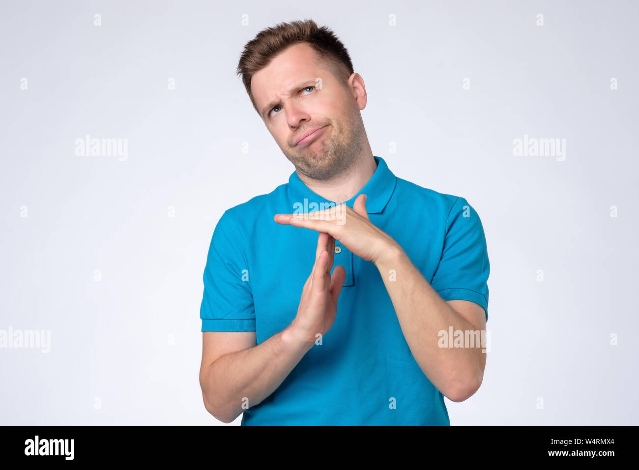 Man making time out gesture over grey background Stock Photo