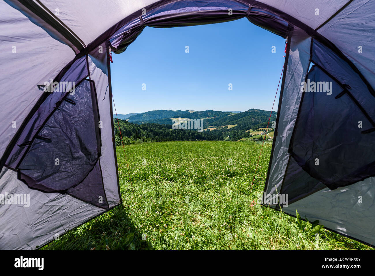 Camping tourist tent set up on meadow in the mountains. Small tent in ...