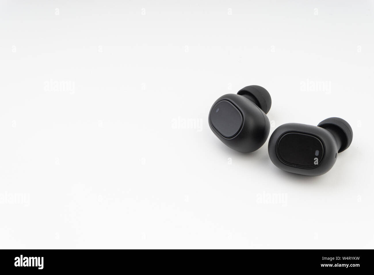 Wireless earbuds or earphones on white background Stock Photo Alamy