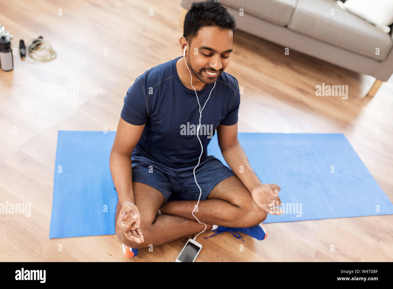 indian man meditating in lotus pose at home Stock Photo - Alamy