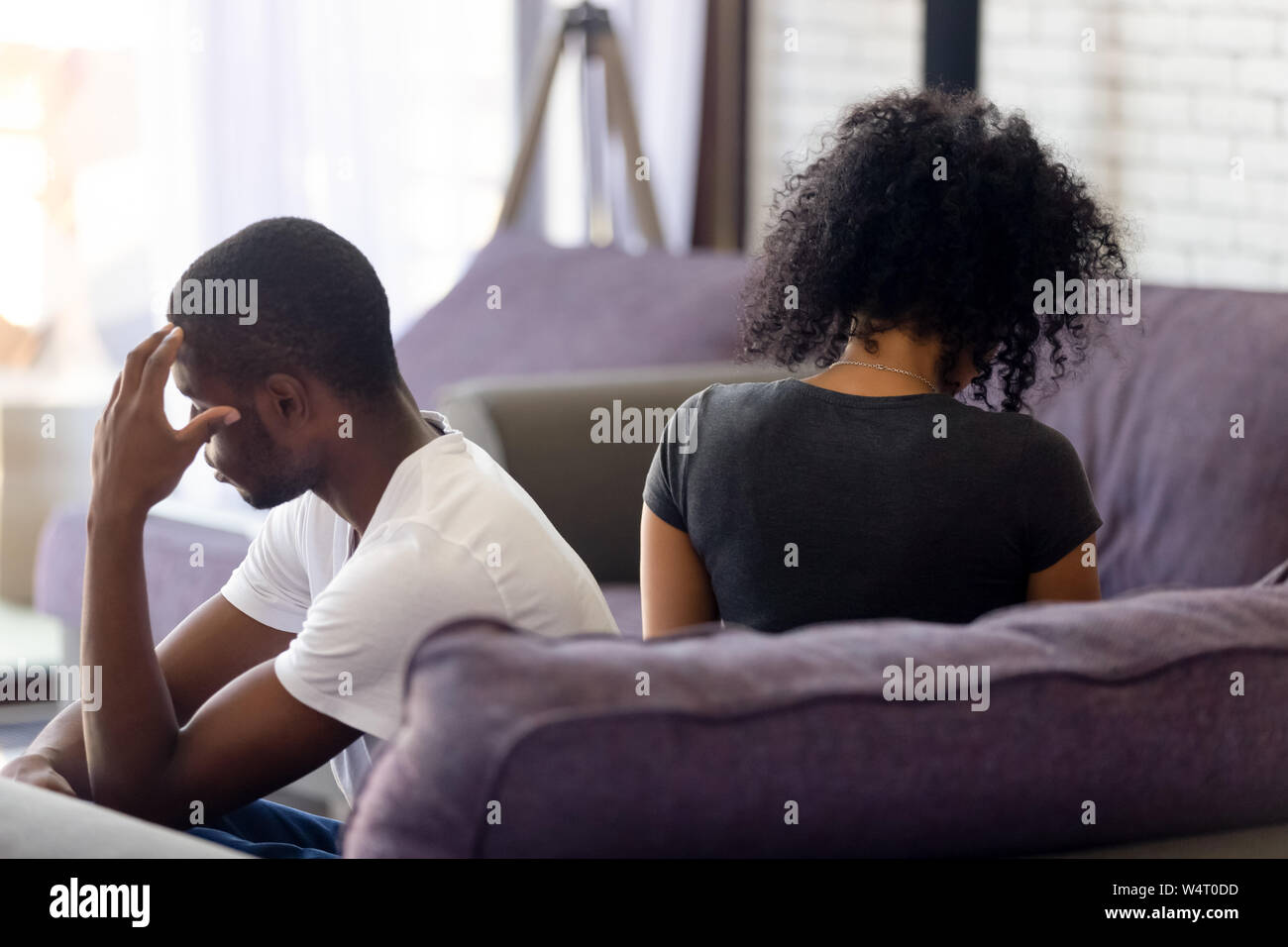 Rear view black couple sitting separately on couch not talking Stock ...