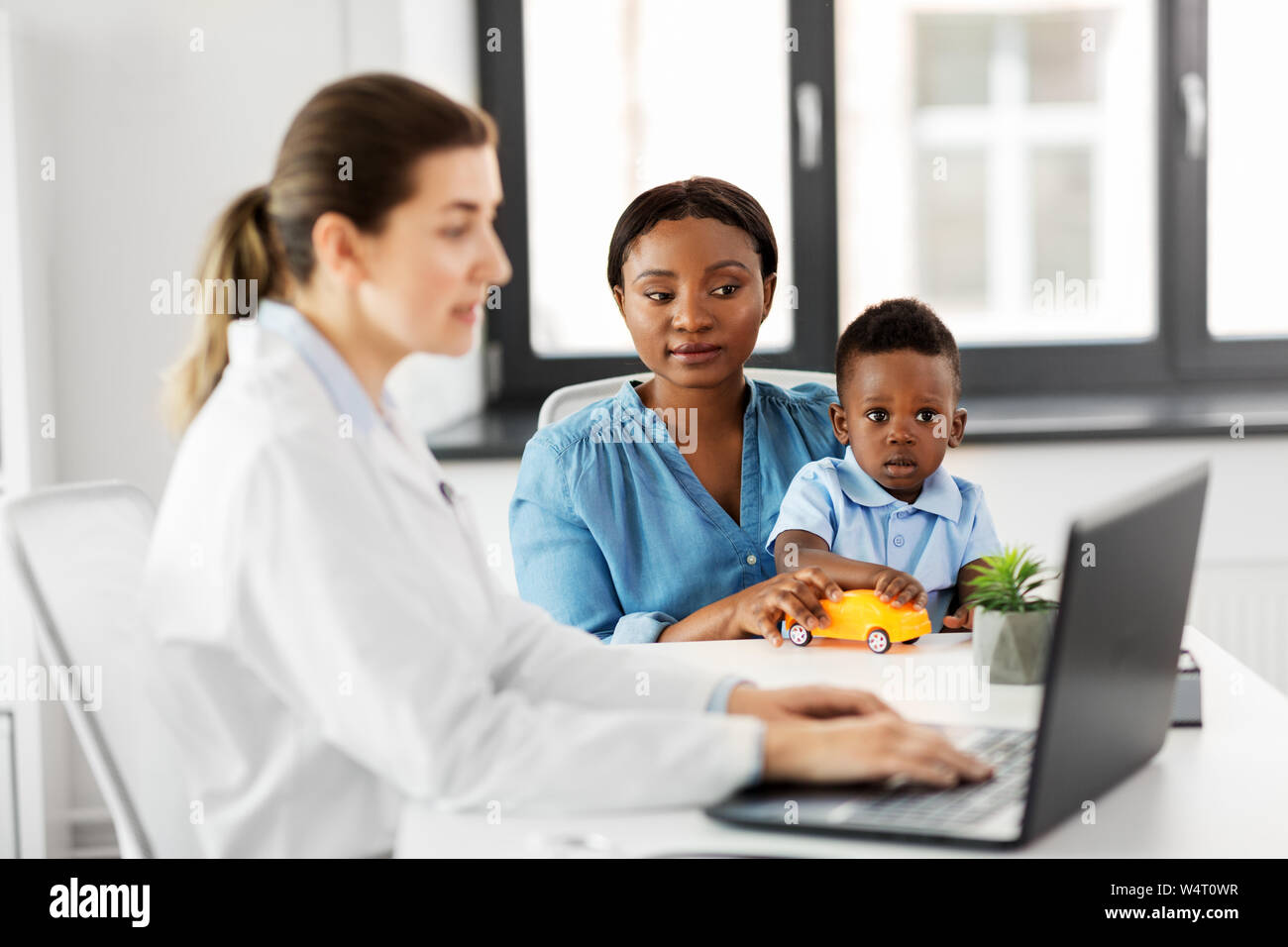 mother with baby son and doctor at clinic Stock Photo - Alamy