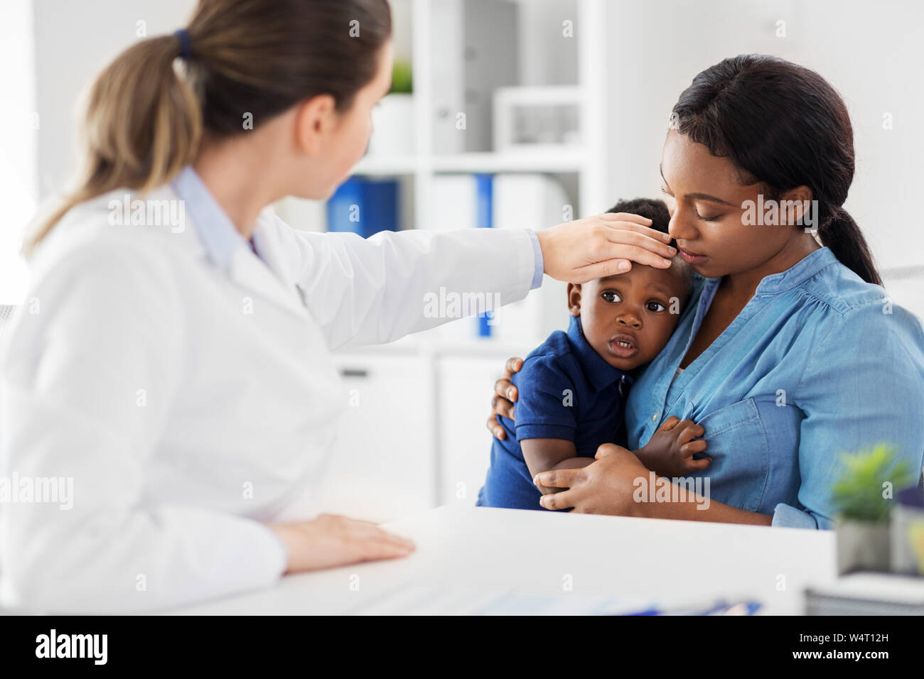mother with sick baby son and doctor at clinic Stock Photo - Alamy