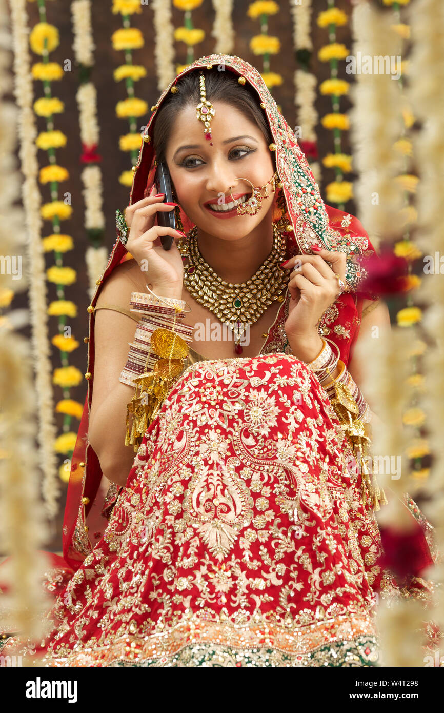 Punjabi bride on mobile phone Stock Photo - Alamy