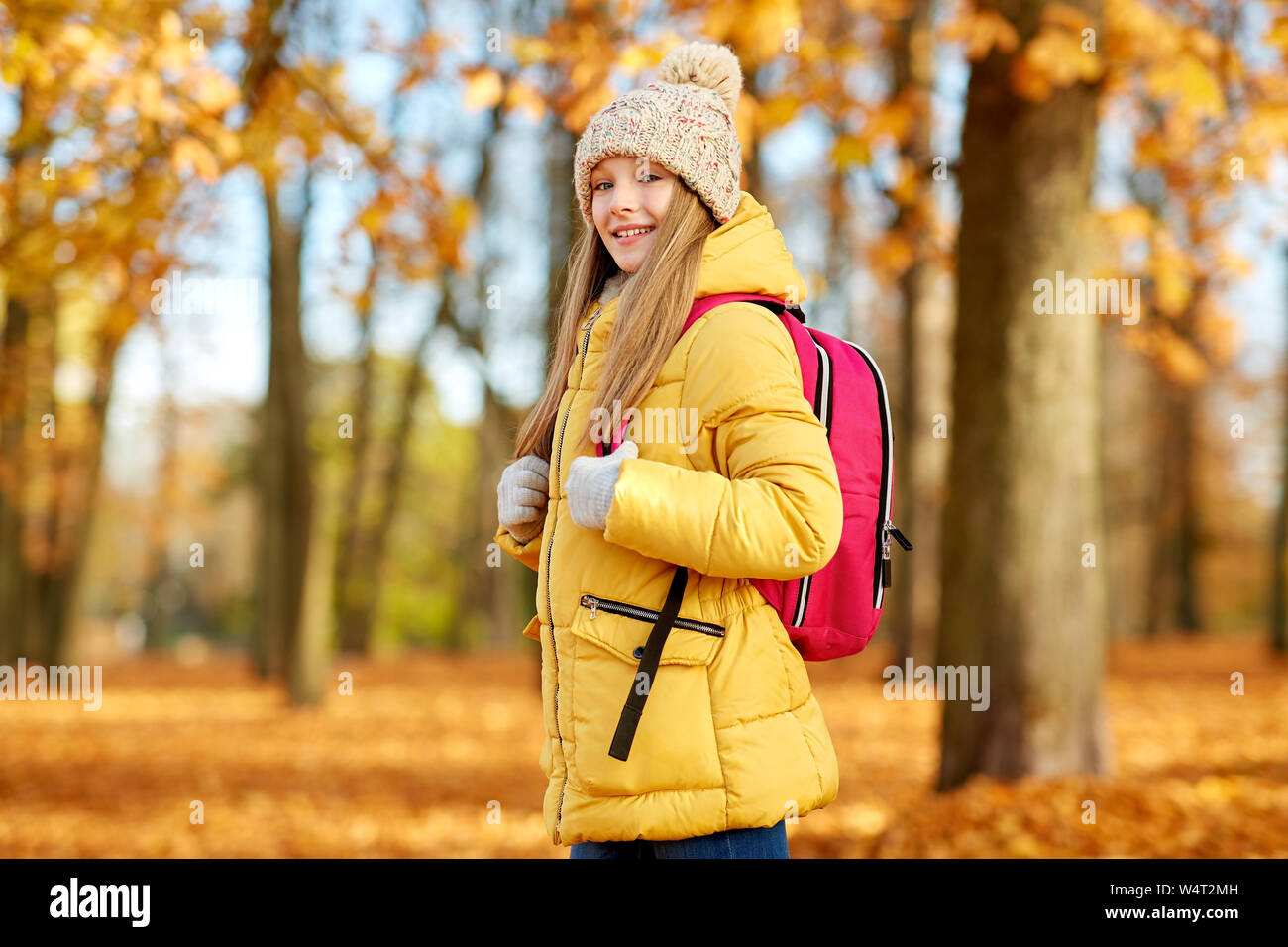 happy student girl with schoolbag at autumn park Stock Photo