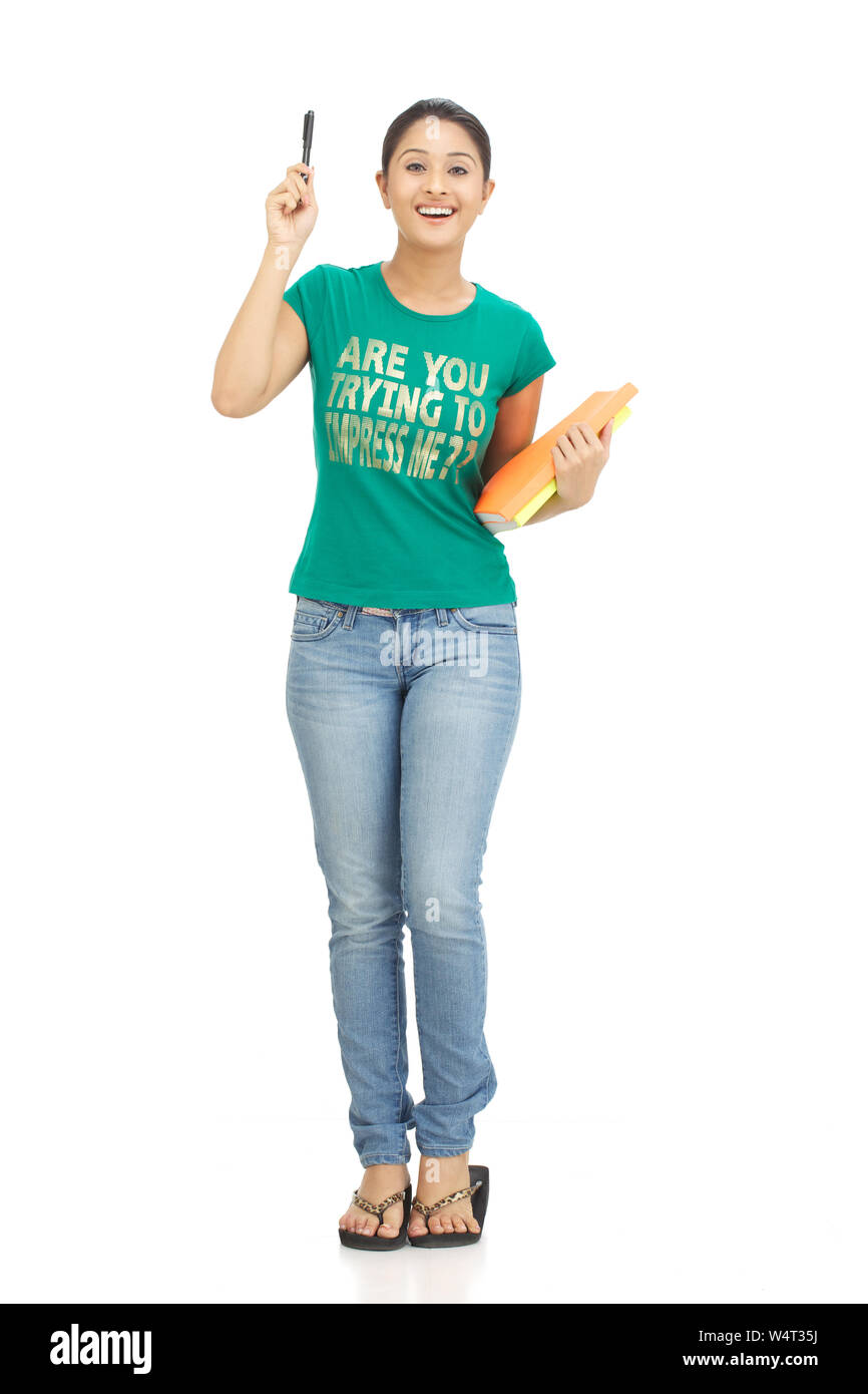 College girl holding books and smiling Stock Photo - Alamy