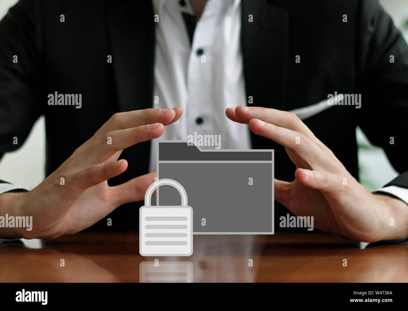 Businessman protecting a secured folder with his hands Stock Photo