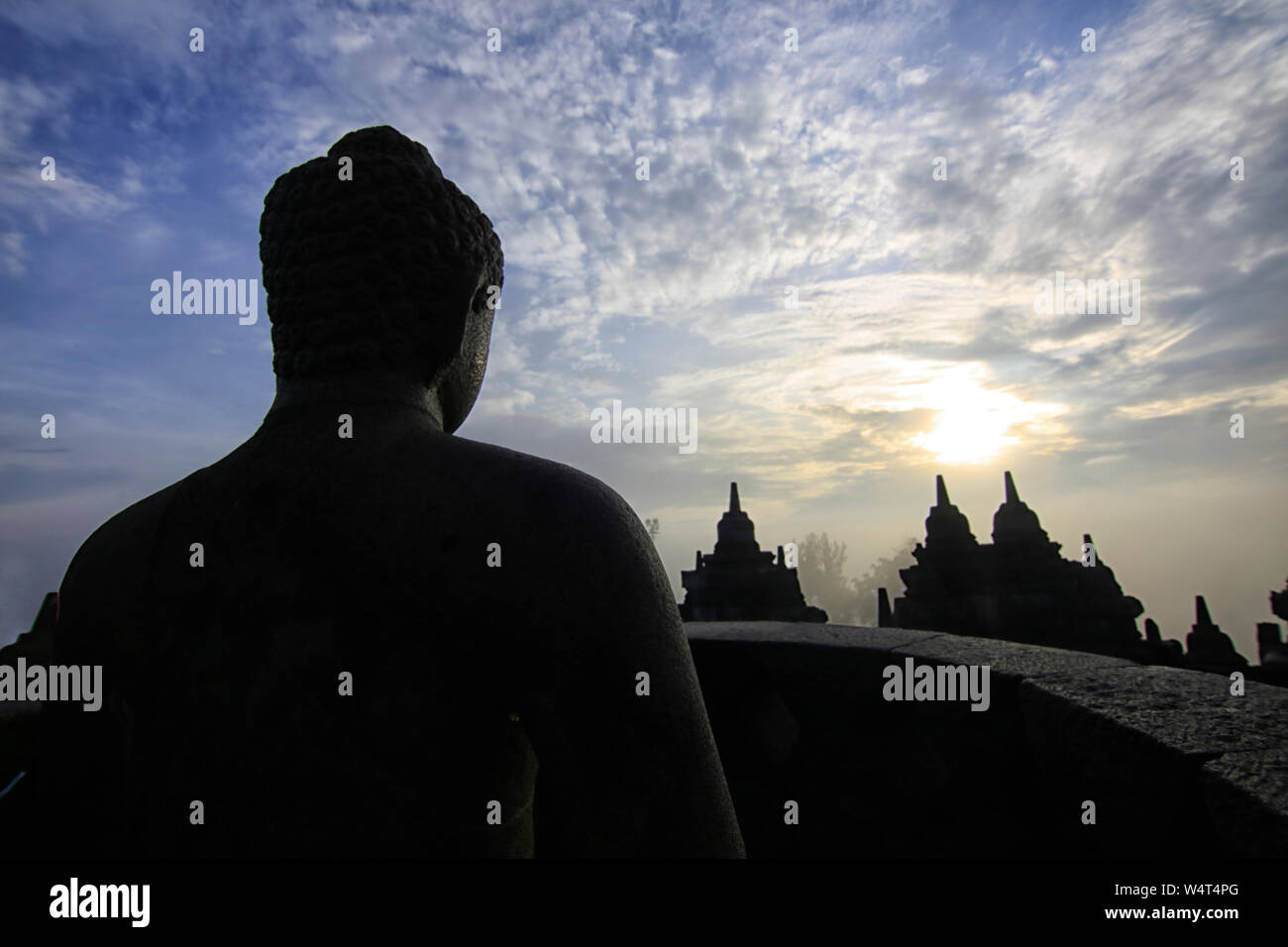 Silhouette of a Buddha statue at sunrise, Borobudur Temple, Magelang, Central Java, Indonesia Stock Photo