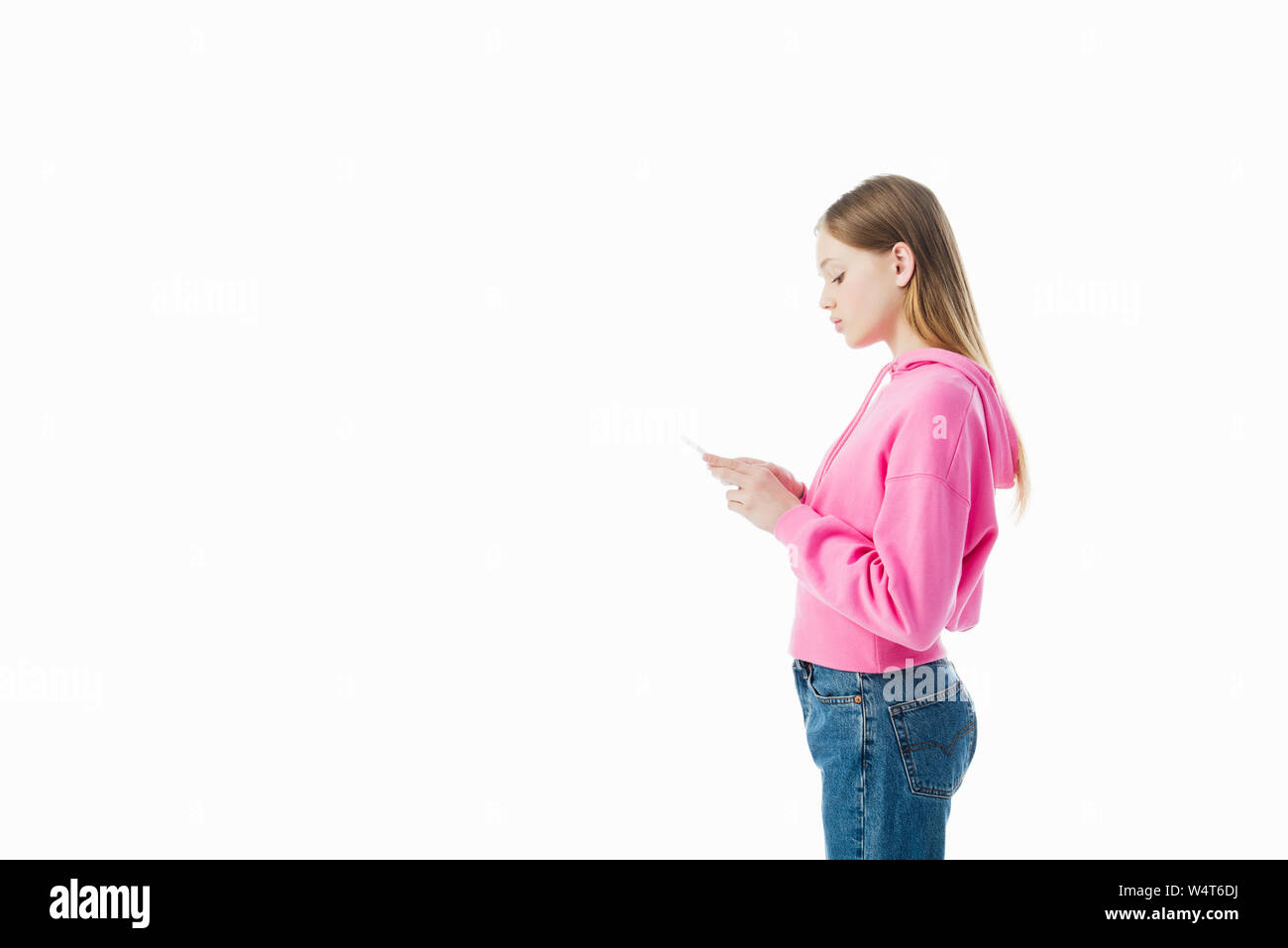 Download Side View Of Teenage Girl In Pink Hoodie Using Smartphone Isolated On White Stock Photo Alamy