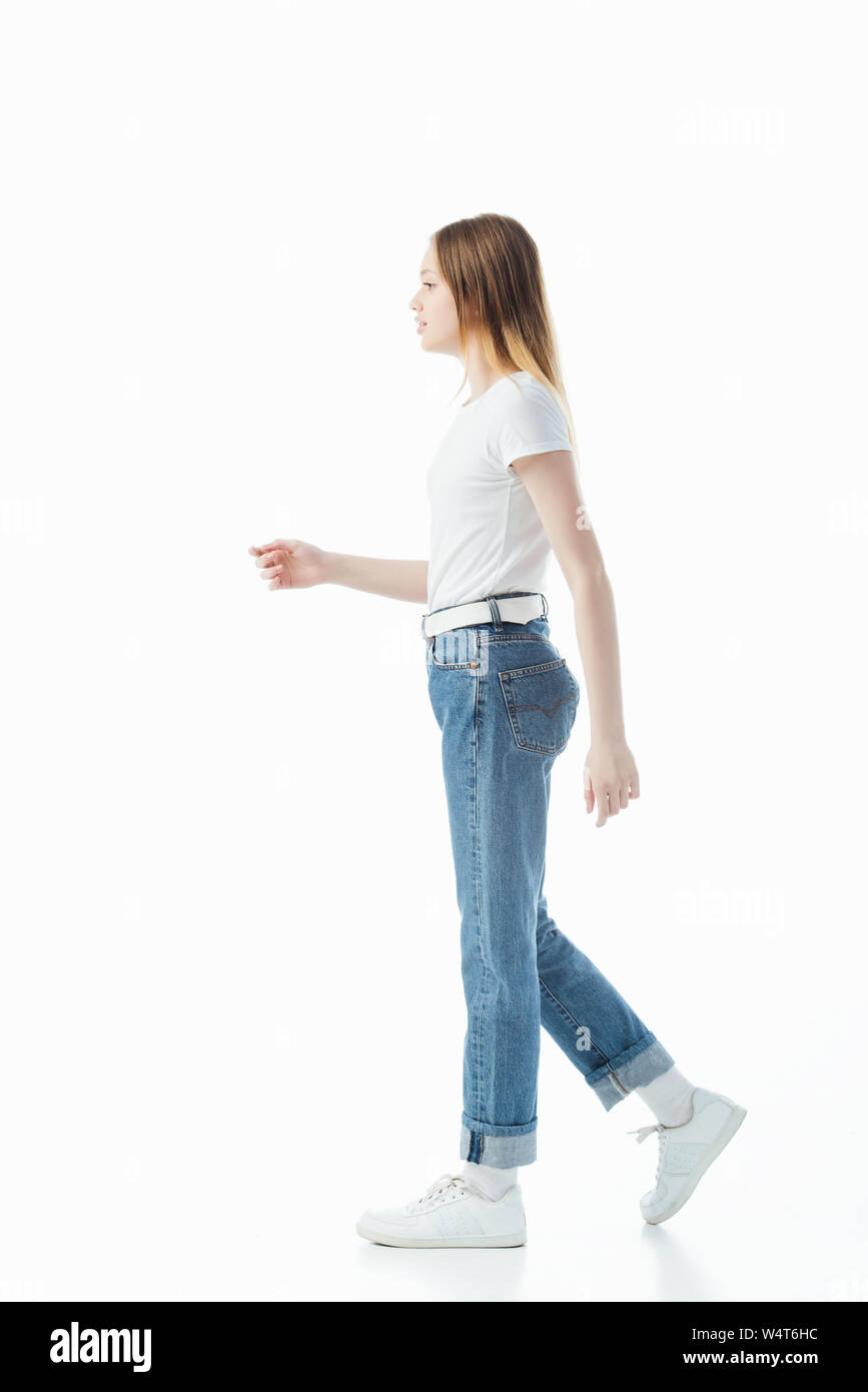 side view of teenage girl in blue jeans and white t-shirt walking isolated  on white Stock Photo - Alamy