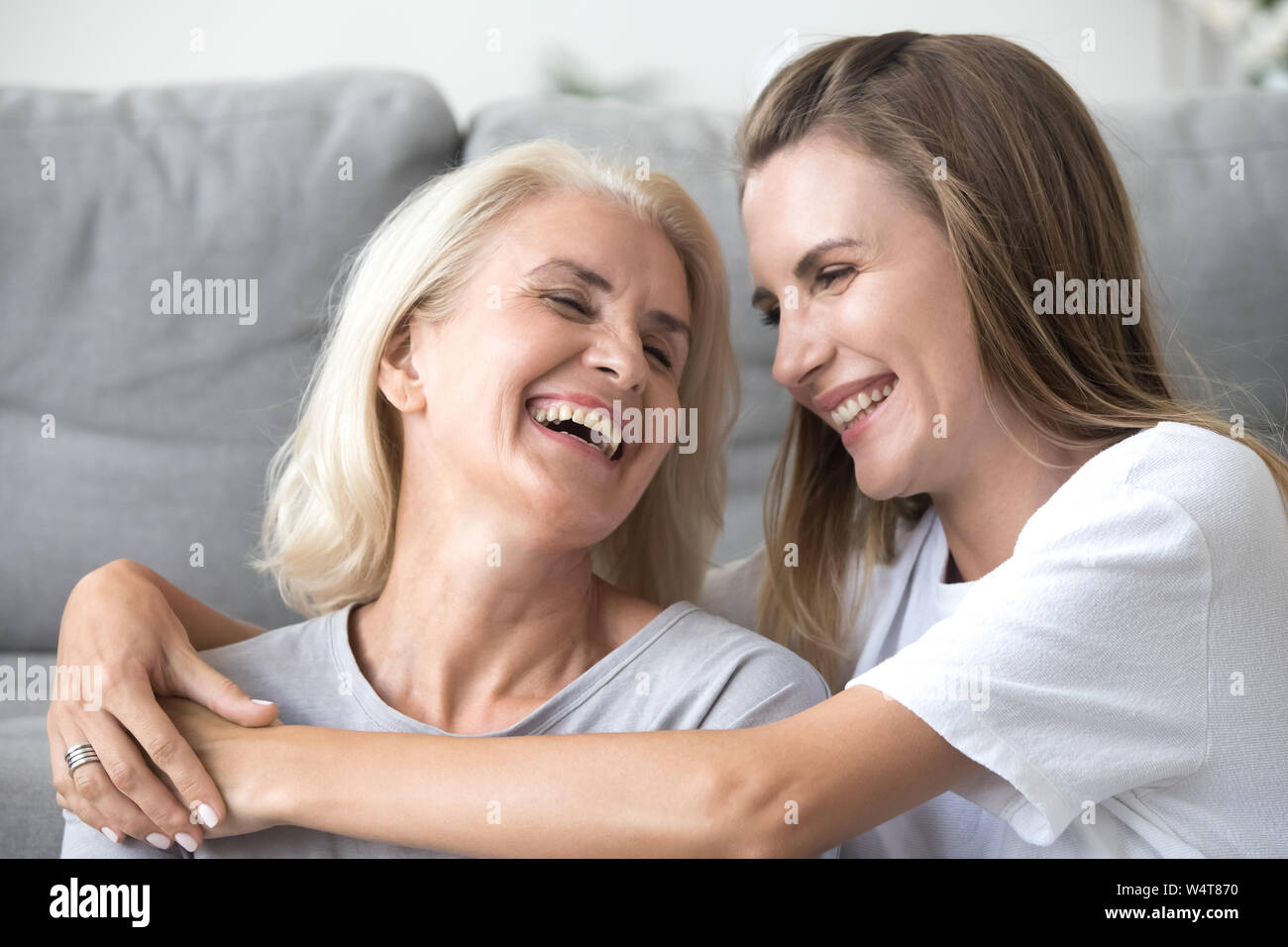 Mother and young daughter laughing having fun together at home Stock Photo