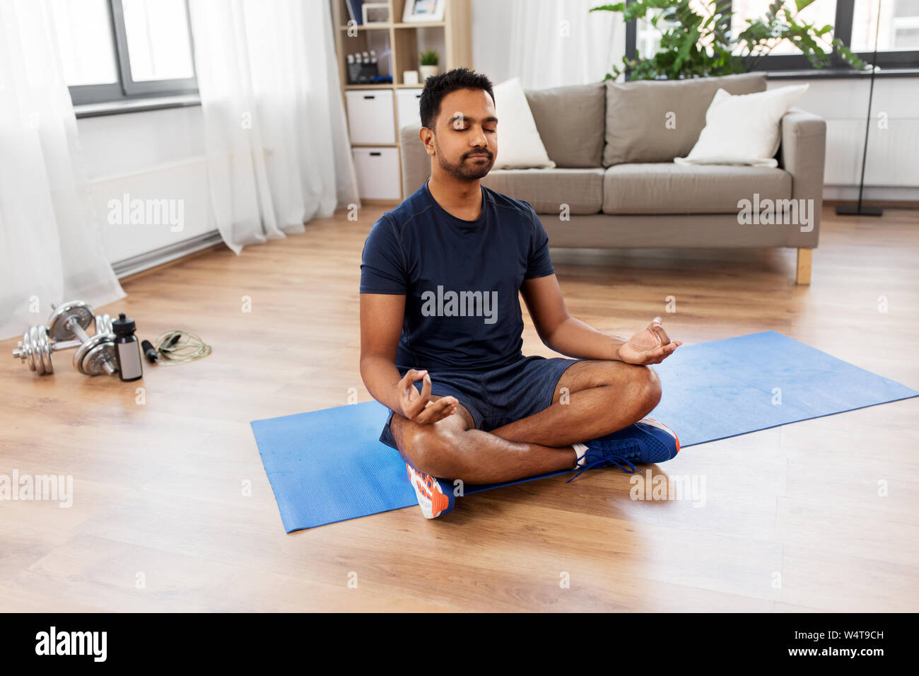 indian man meditating in lotus pose at home Stock Photo - Alamy