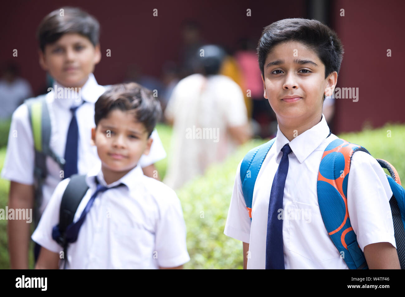 Portrait of schoolboys standing at school campus Stock Photo