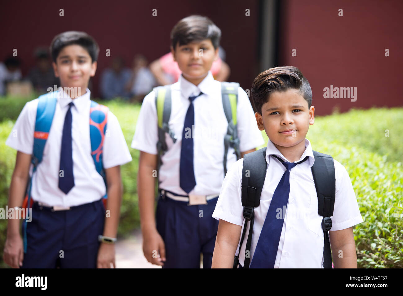 Portrait of schoolboys standing at school campus Stock Photo