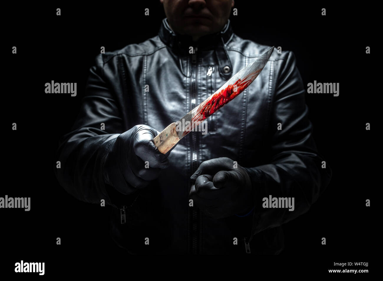 Serial killer maniac with knife and black gloves / killer tools Stock